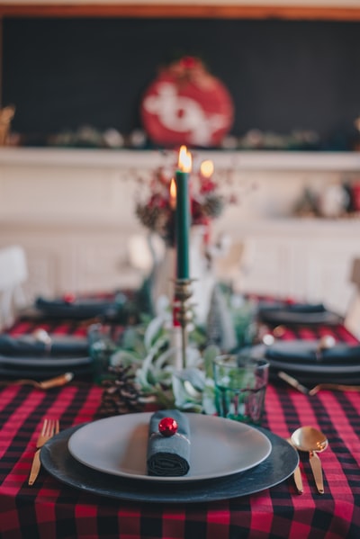 Red and white plaid tablecloth lighted candles
